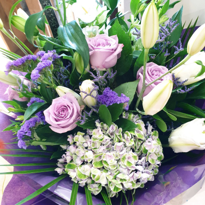 Violet - An impressive hand-tied of purple and white flowers, presented in a complimentary gift bag or box to make your gift feel extra special.
